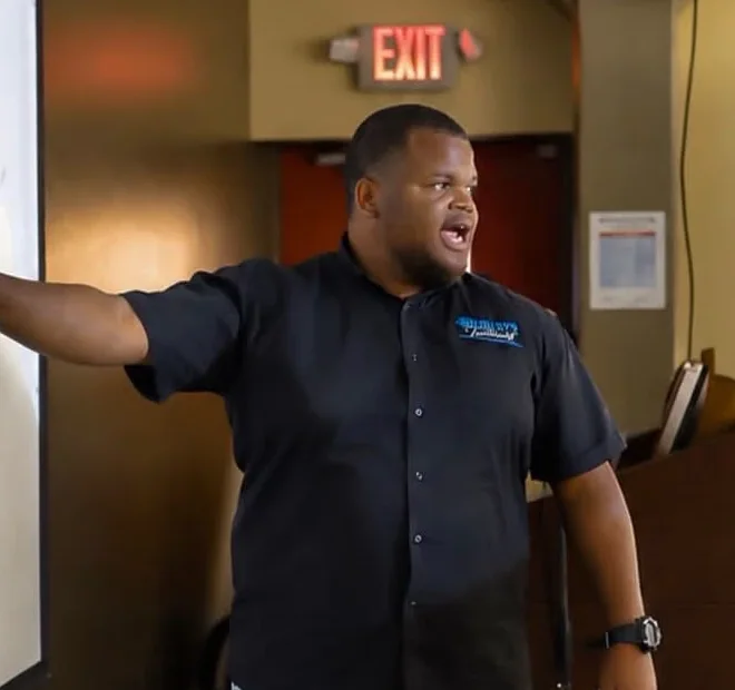 Demar Hemley, founder of Hemley’s Tutoring, teaching in a Hemley’s Tutoring shirt